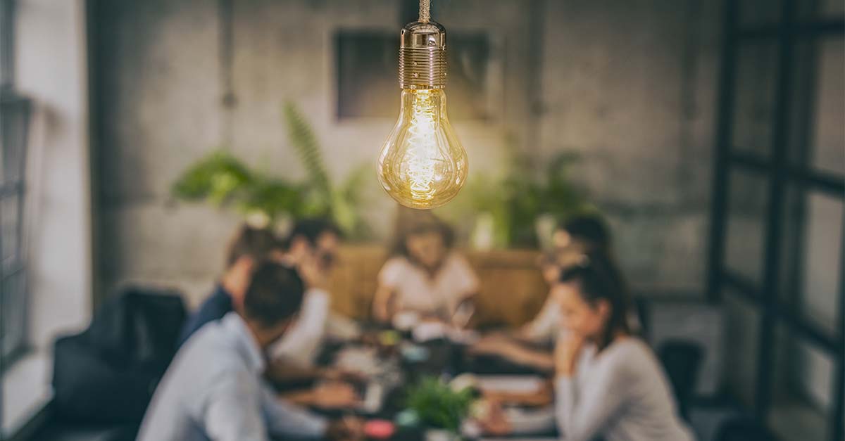 Marketing team at a table discussing an idea.