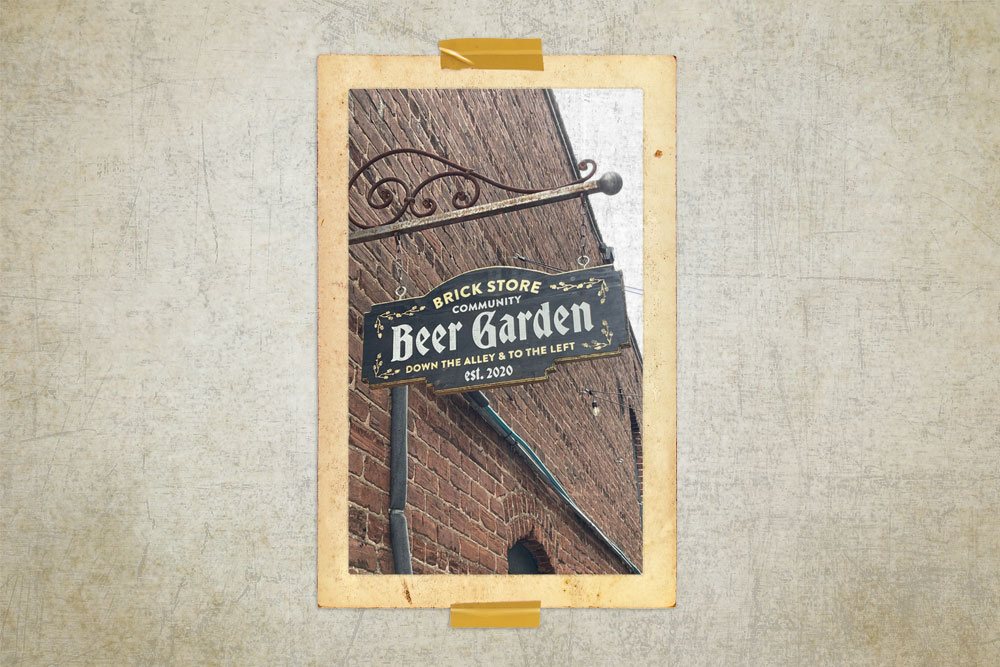 The Brick Store Pub Beer Garden sign in the alley way by the pub.
