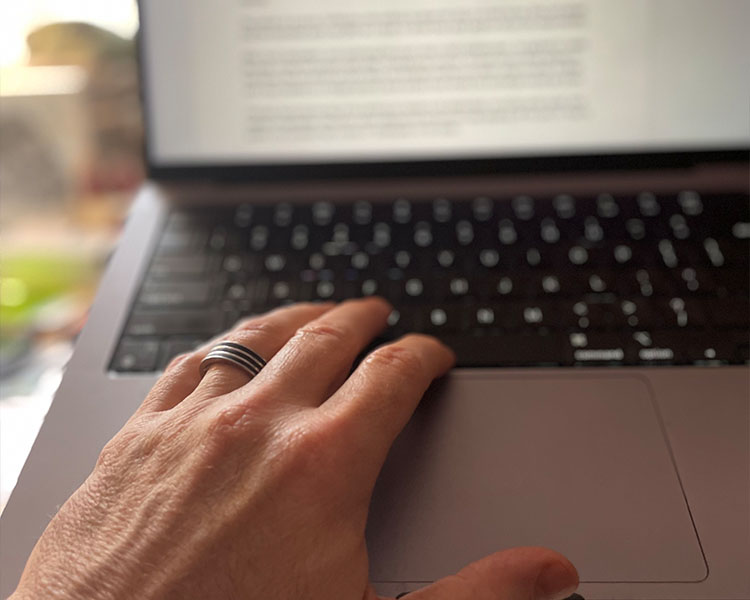 Jon Waterhouse's hand on his laptop keyboard.